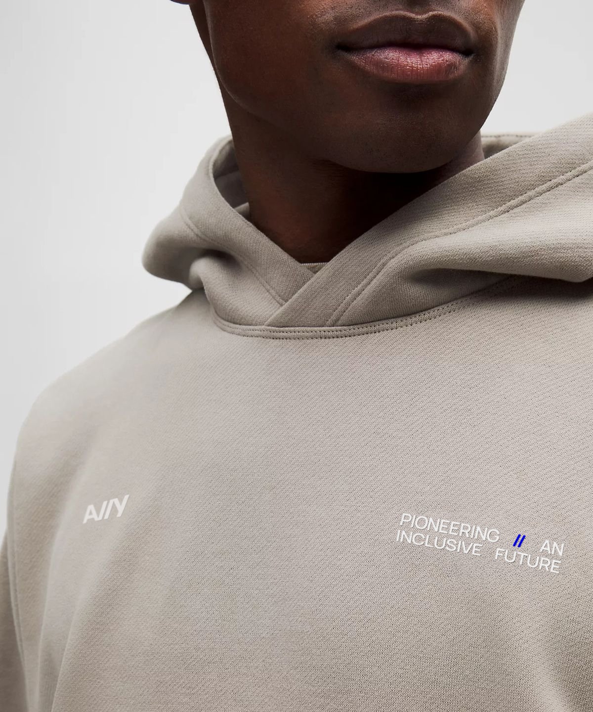 Sand hoodie with the A11Y mark and Pioneering an Inclusive Future.