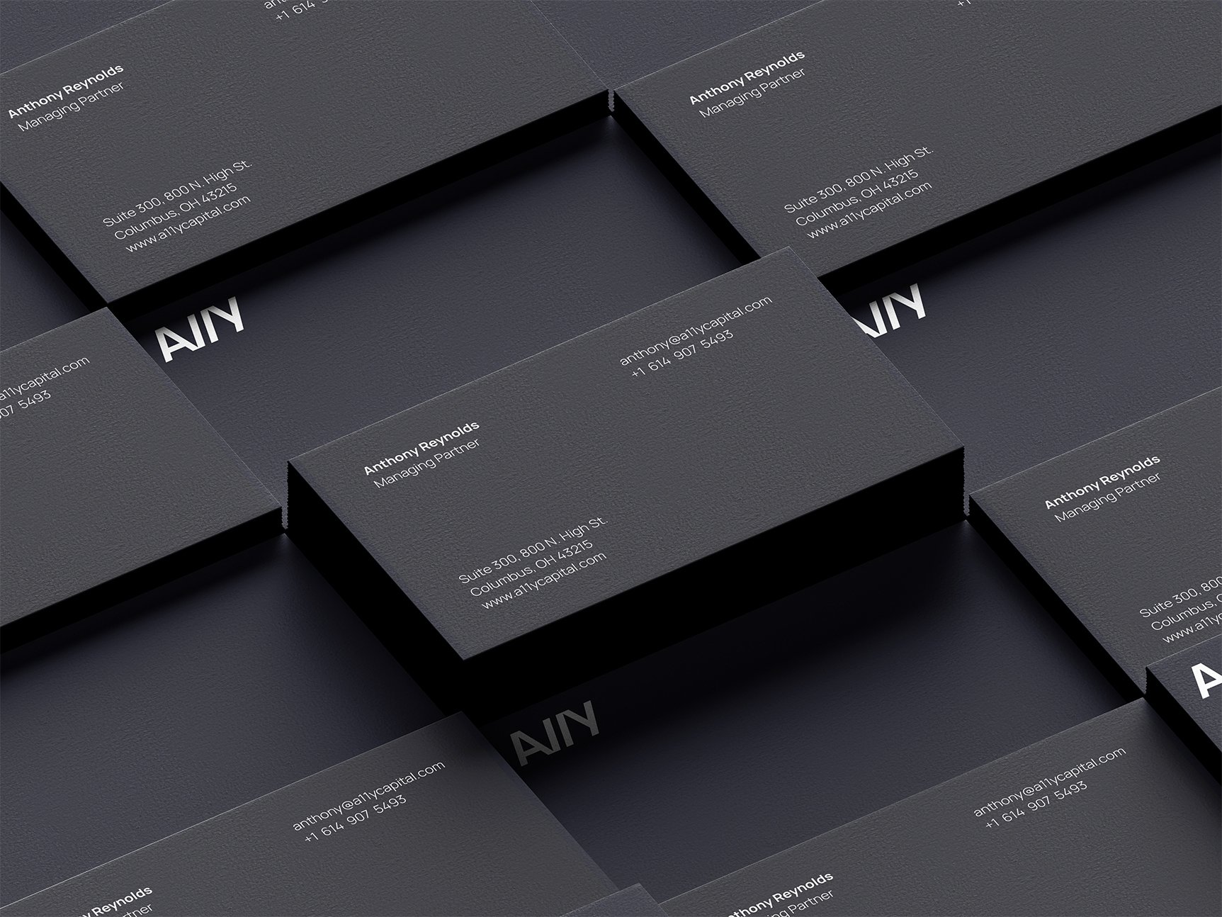 Stacked dark A11Y business cards for Anthony Reynolds, Managing Partner.