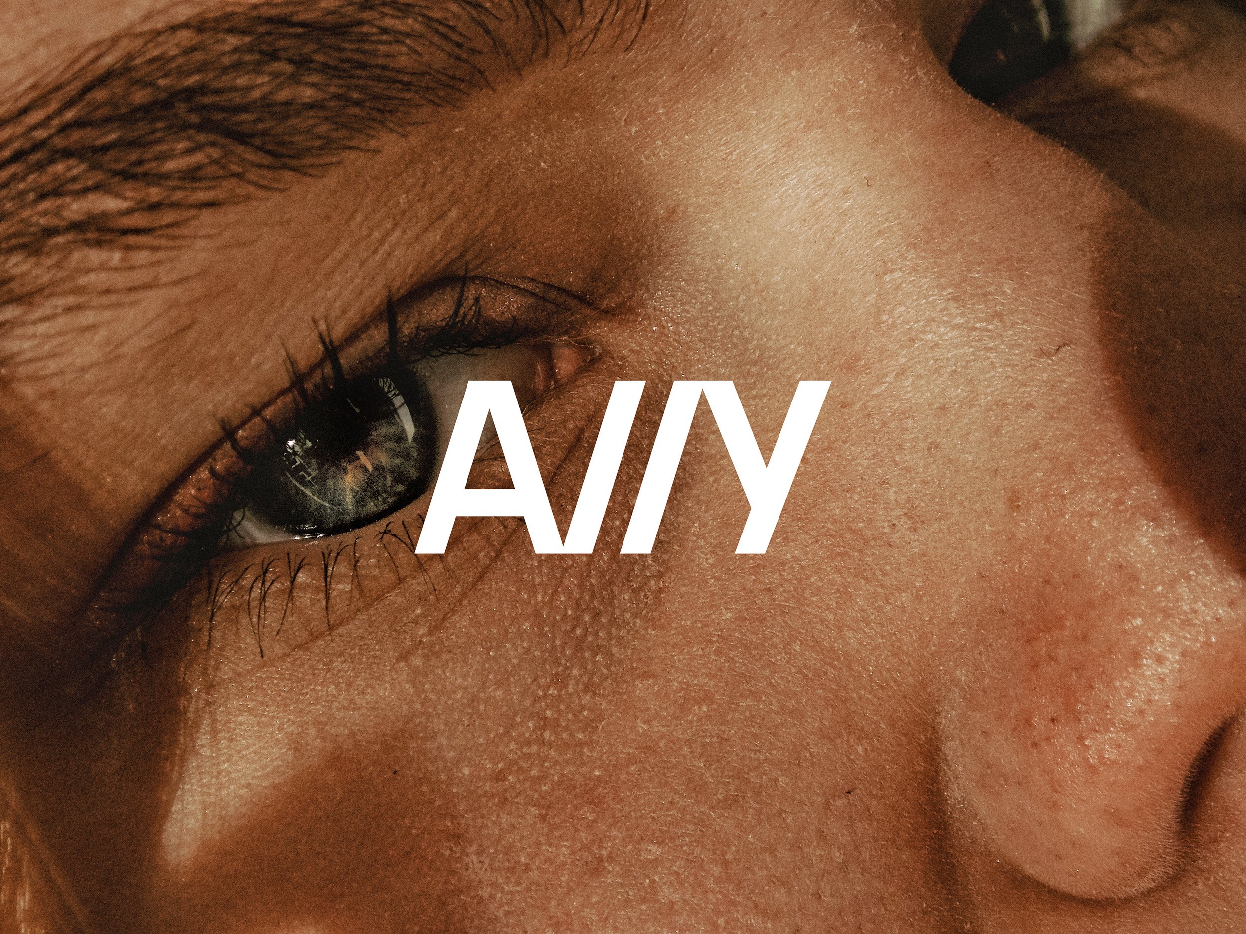 A11Y wordmark overlaid on a close-up portrait.