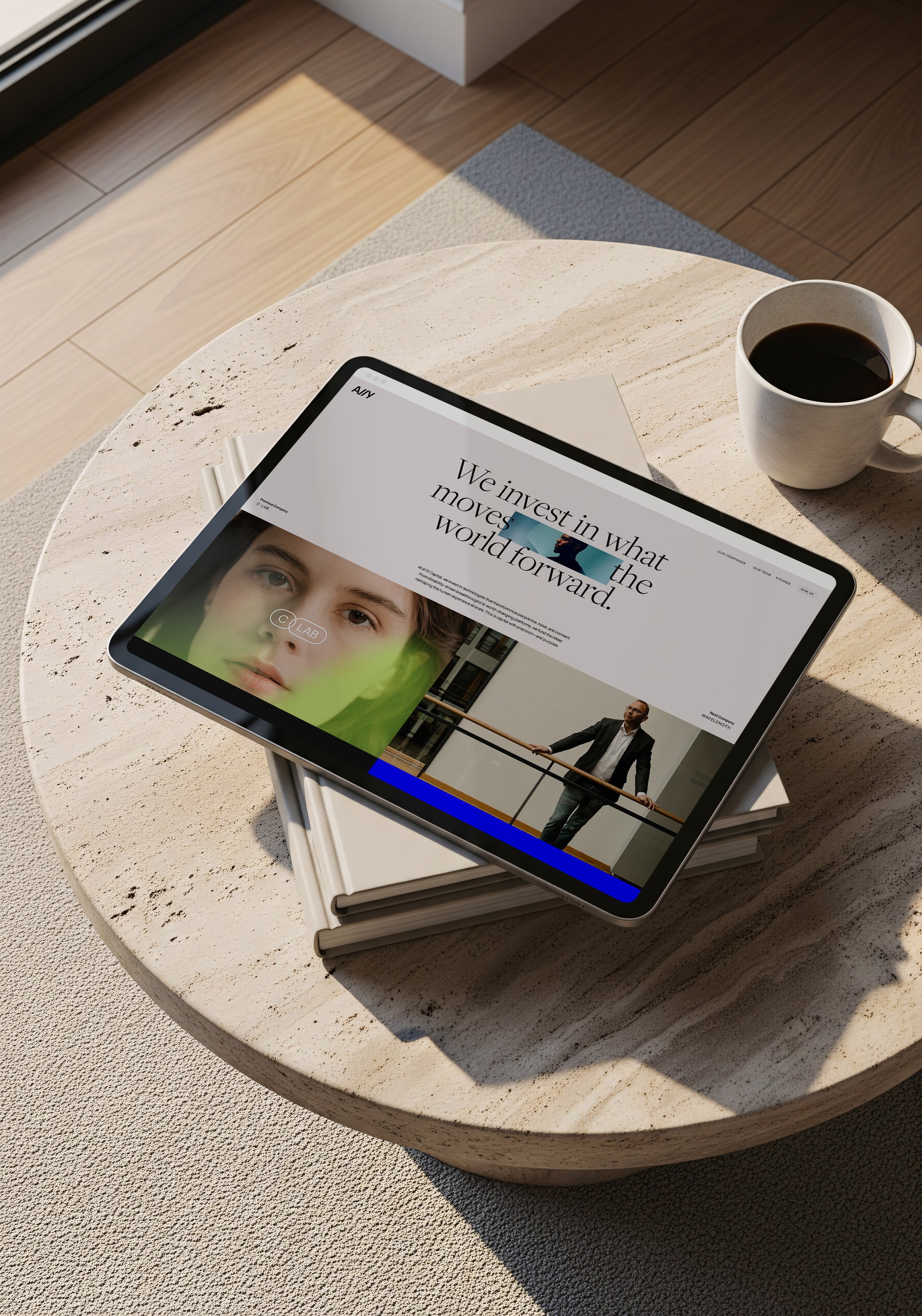 Tablet on a marble table showing the A11Y site: We invest in what moves the world forward.