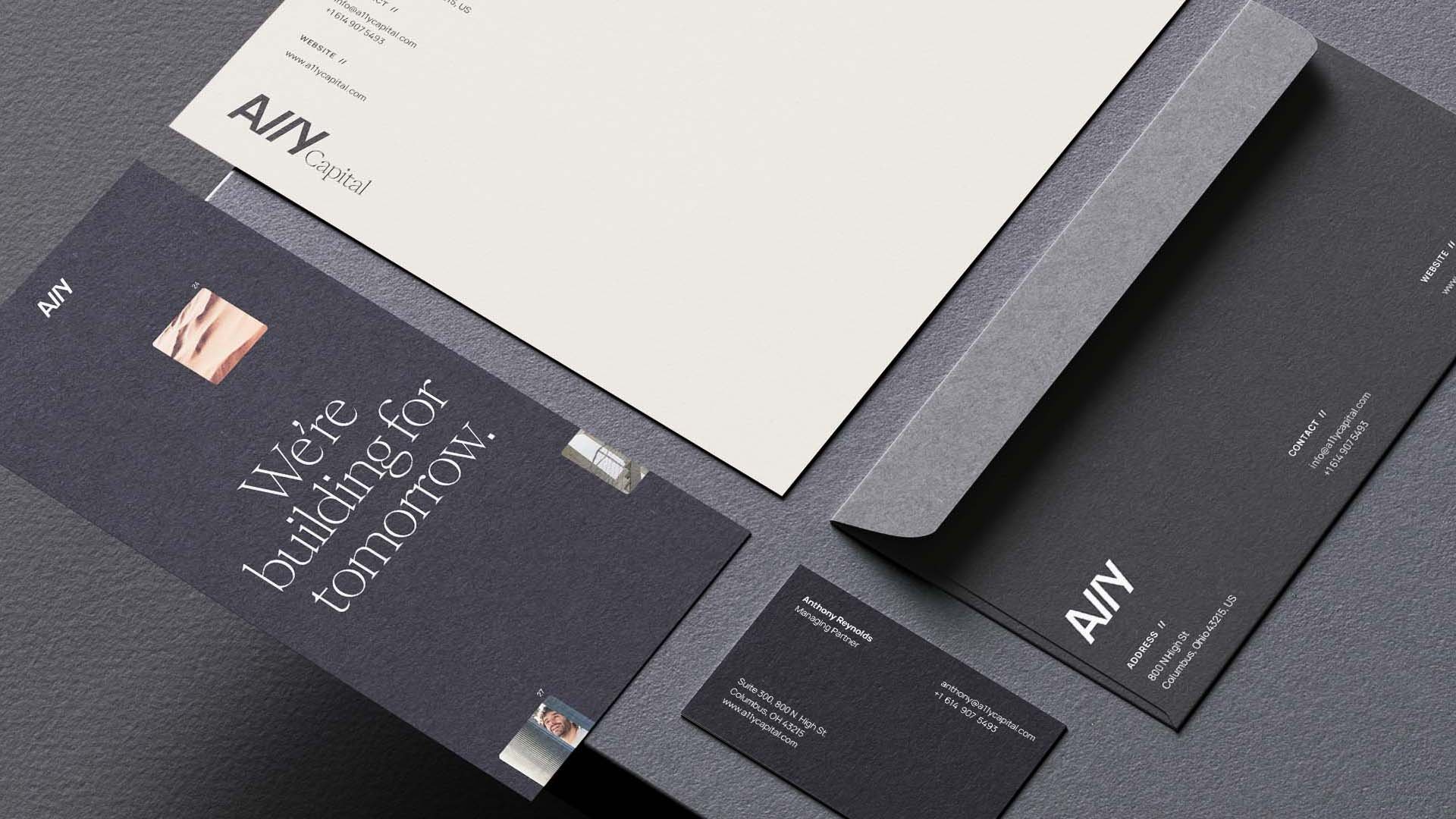 A11Y stationery system with a dark business card, letterhead, and envelope.