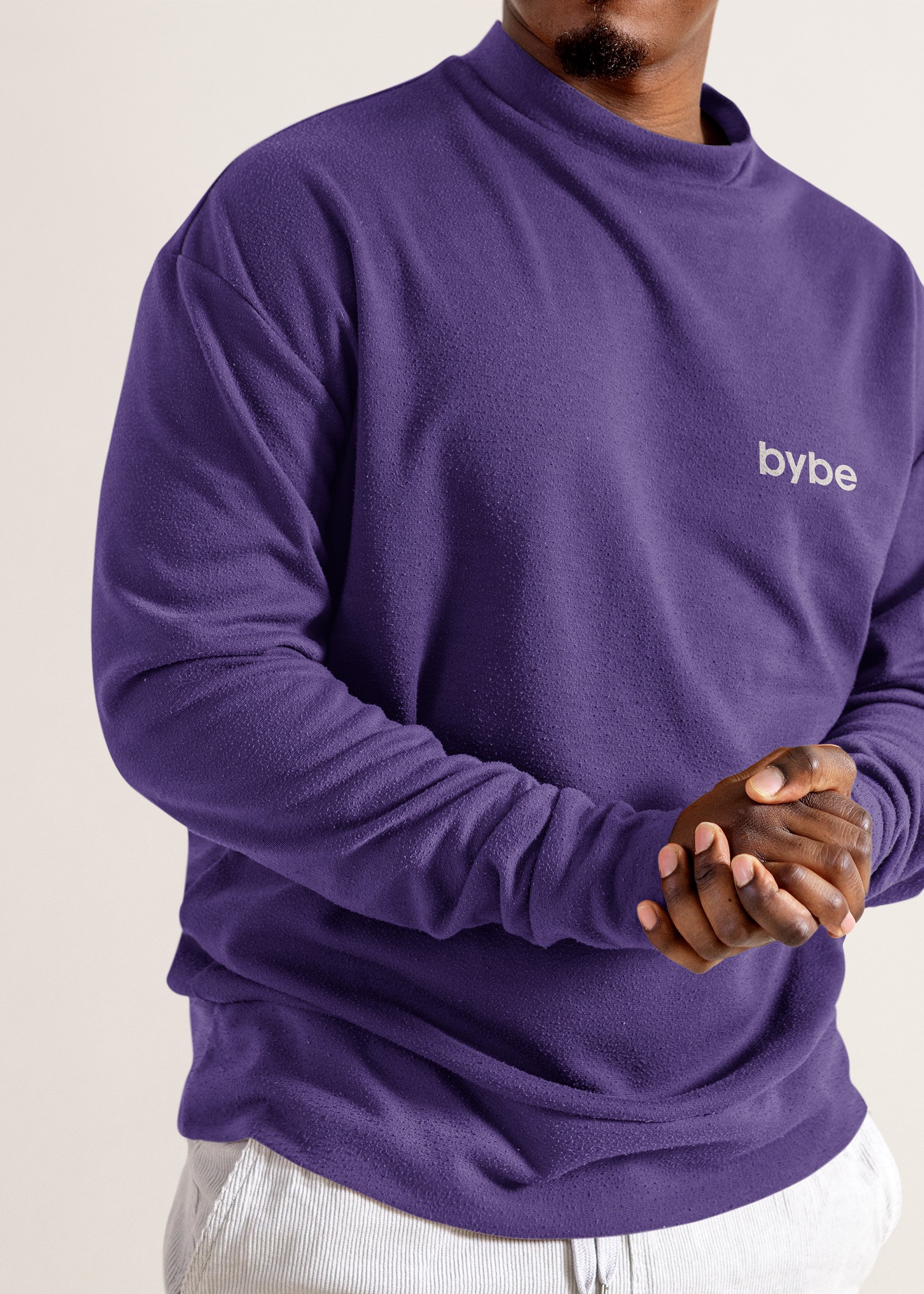 Person wearing a purple Bybe sweatshirt.