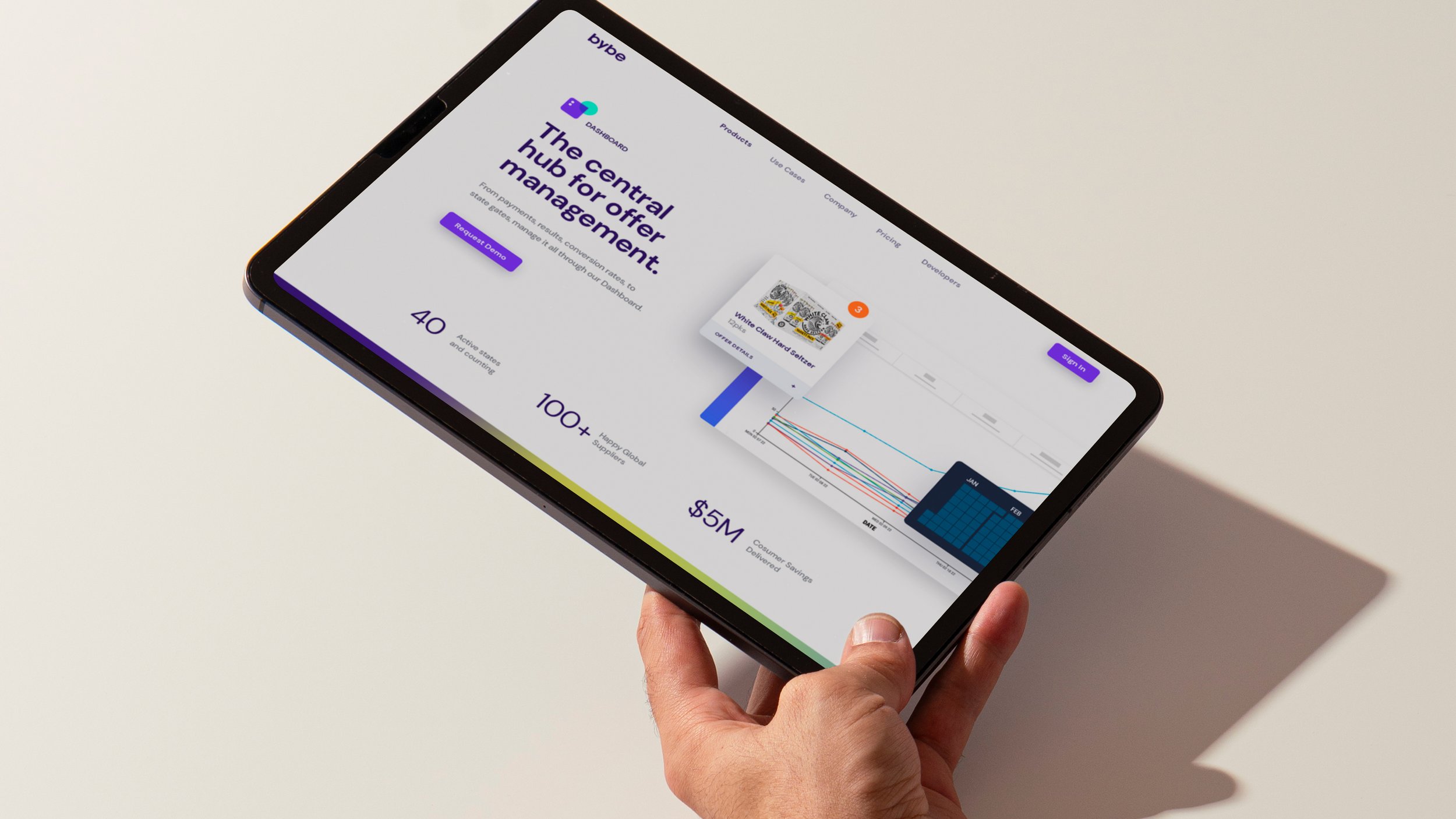 Person holding a tablet showing the Bybe hub management website.