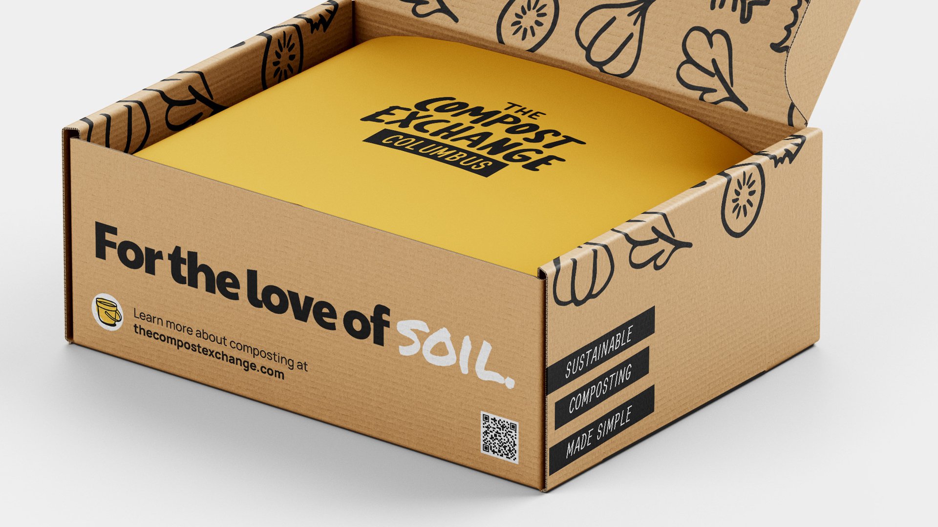 Open Compost Exchange mailer box lined in yellow, printed “For the love of soil.”