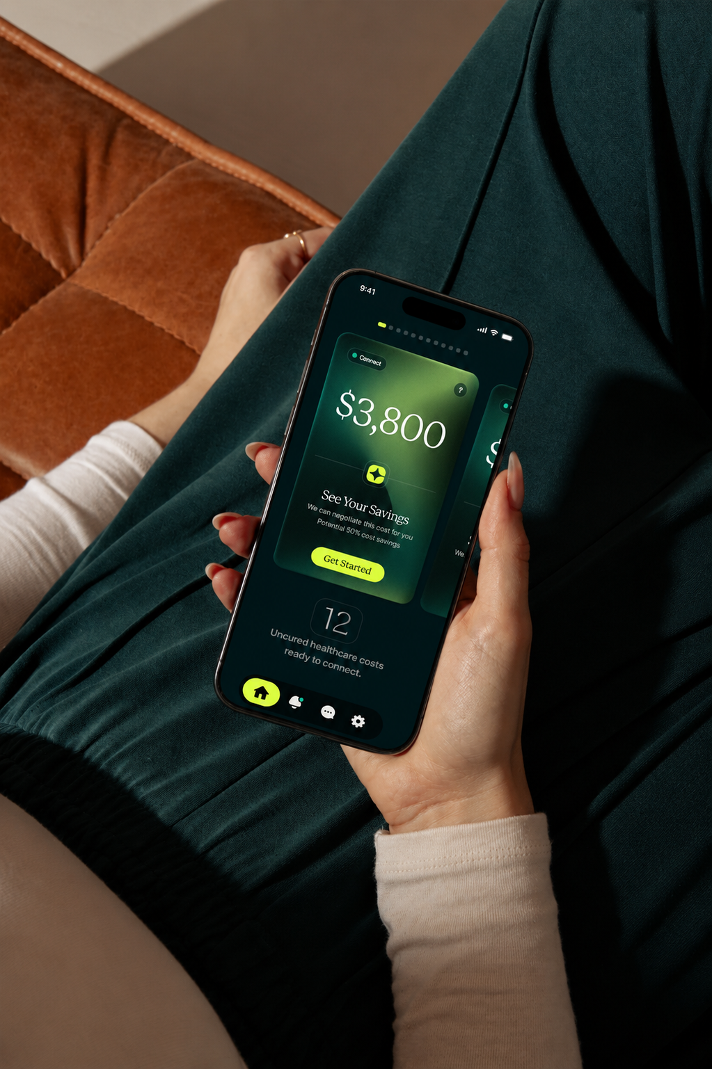 Hand holding a phone that shows a $3,800 savings screen on a dark green field.