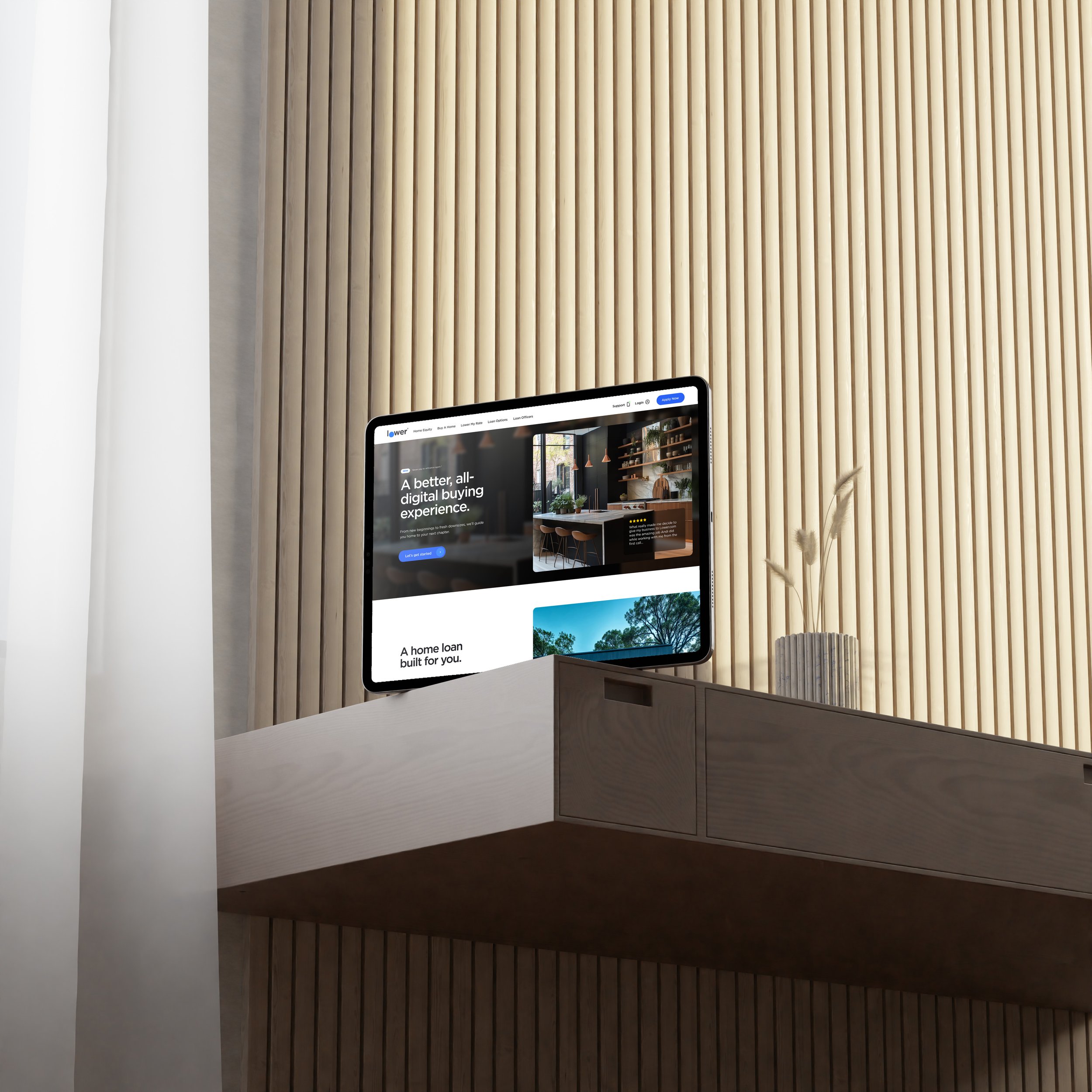iPad on a white shelf in front of a wooden slat wall, displaying the Lower website.