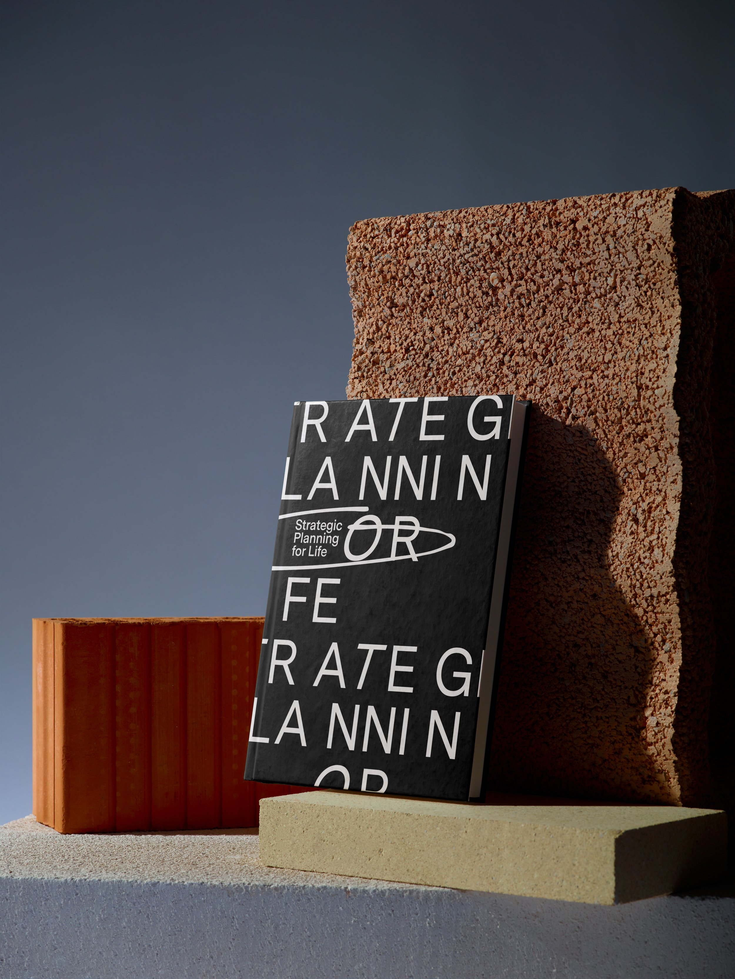 Strategic Planning for Life book mockup with geometric brand forms.