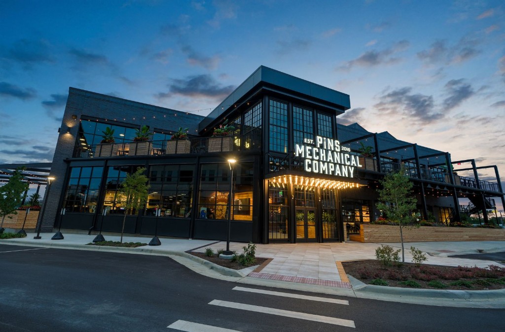 Pins Mechanical Company venue exterior at dusk, with the entrance lit.