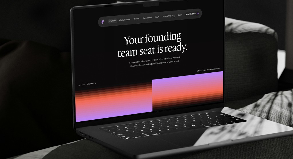 Laptop showing the symmitri founding-team website.