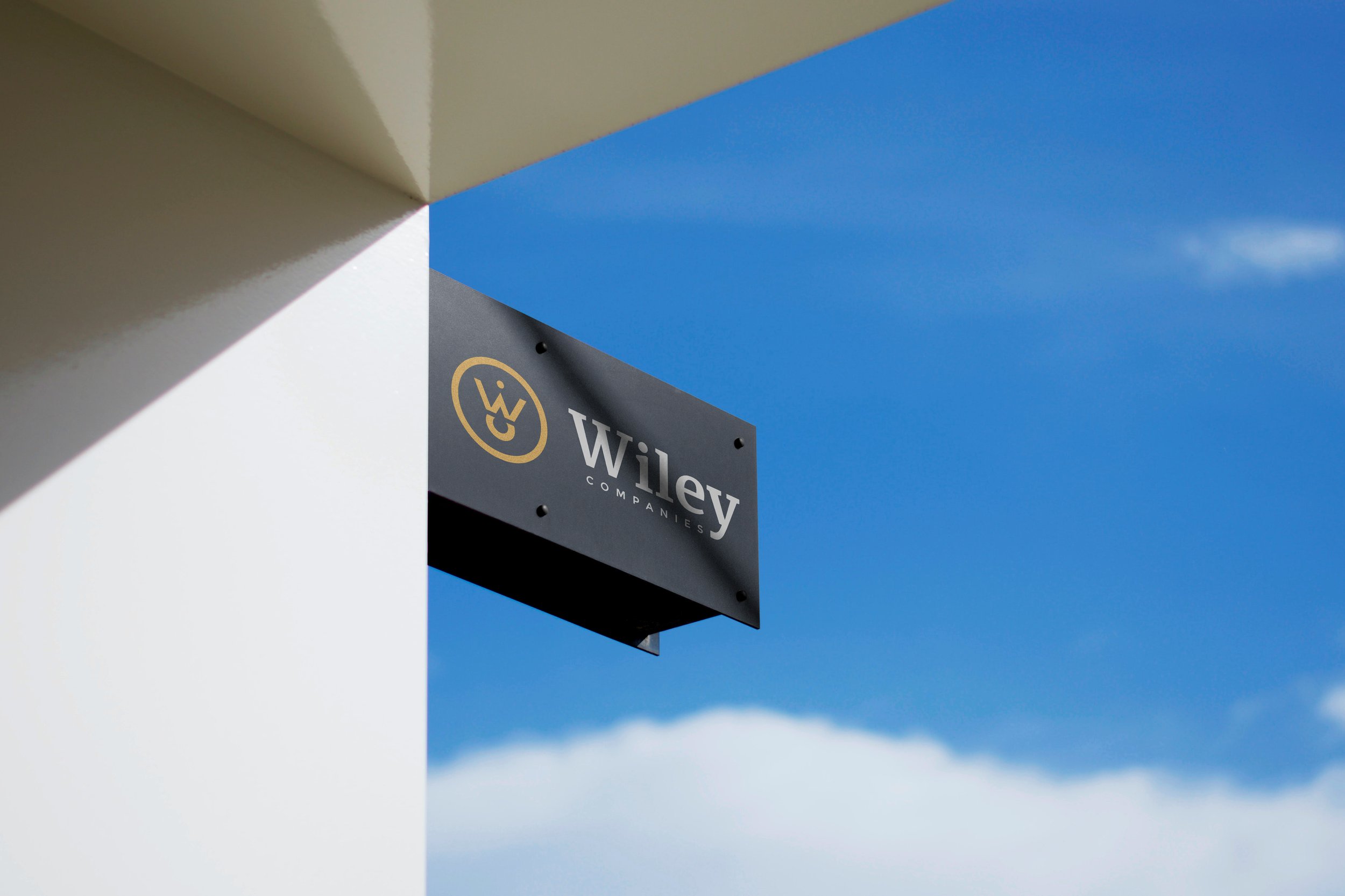 Wiley Companies exterior building sign against a blue sky.